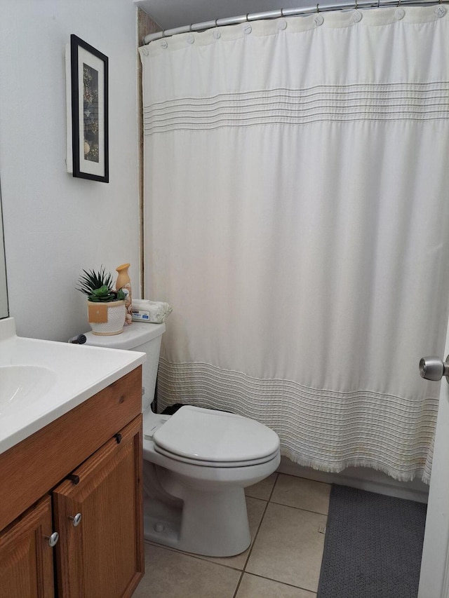 full bath featuring toilet, curtained shower, tile patterned flooring, and vanity