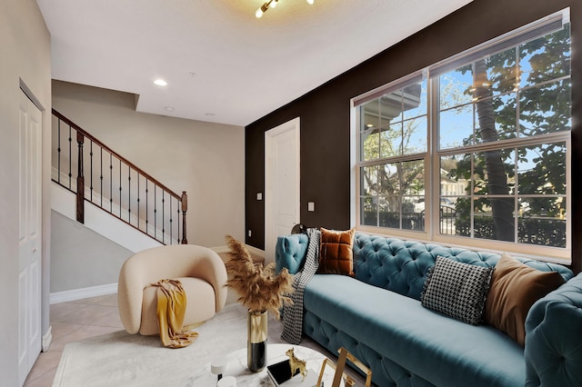 living area with light tile patterned floors, baseboards, stairway, and recessed lighting