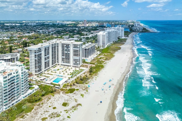 bird's eye view with a city view, a water view, and a beach view