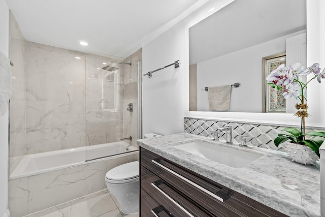 bathroom featuring decorative backsplash, a combined bath / shower with marble appearance, toilet, marble finish floor, and vanity