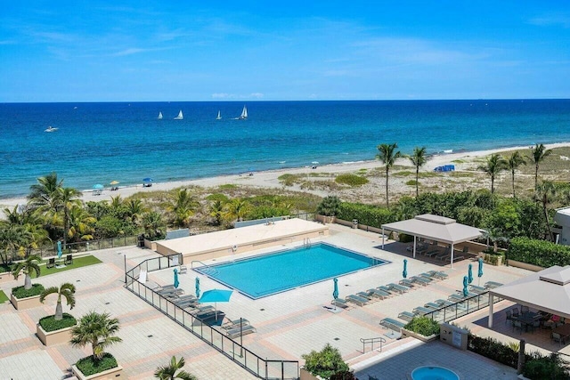 exterior space featuring a water view and a beach view