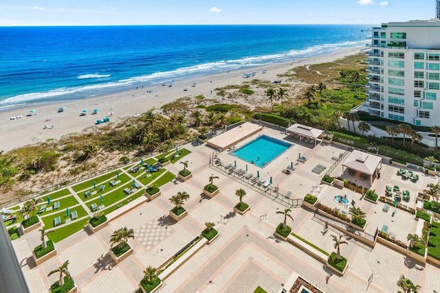 drone / aerial view featuring a beach view and a water view