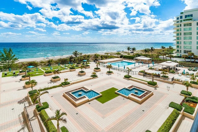 aerial view with a water view and a beach view