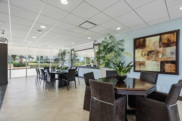 dining room featuring a paneled ceiling, baseboards, recessed lighting, and light tile patterned floors