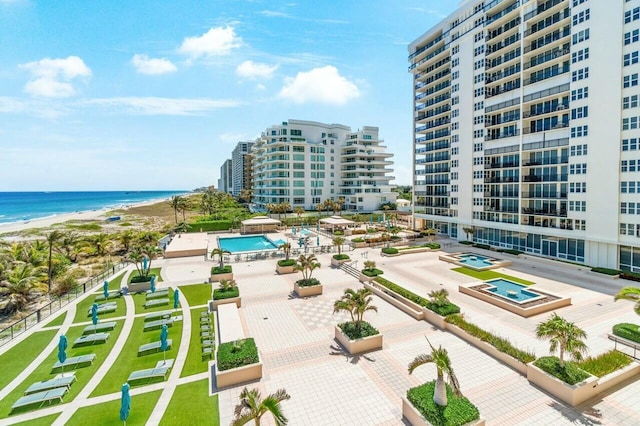 birds eye view of property featuring a beach view, a water view, and a city view