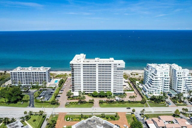 aerial view with a water view, a view of the beach, and a city view