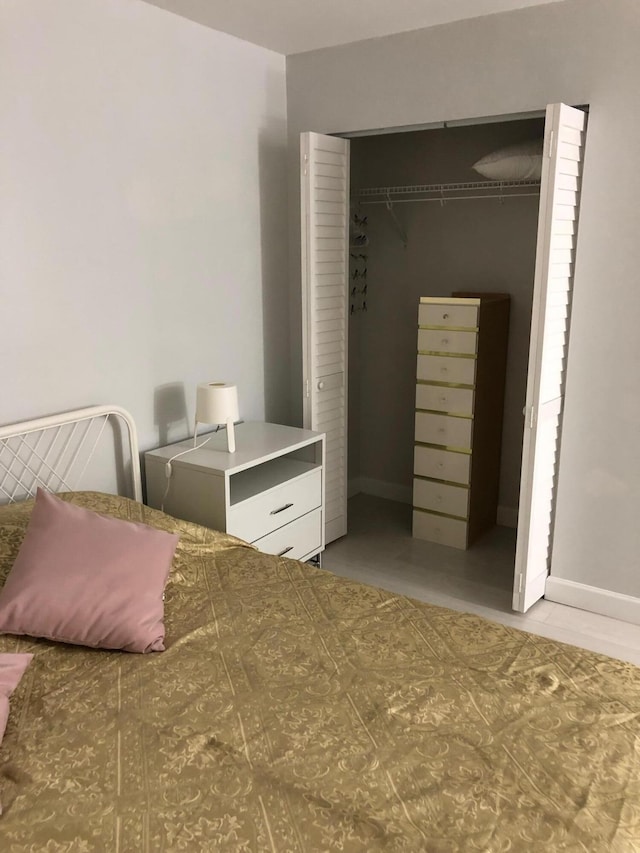 bedroom featuring a closet and baseboards