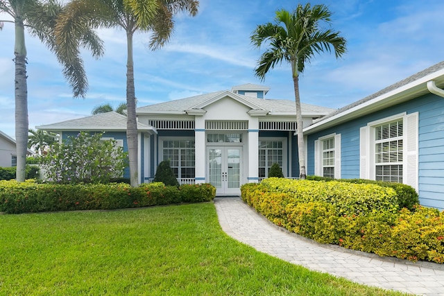 view of front of property featuring french doors and a front lawn