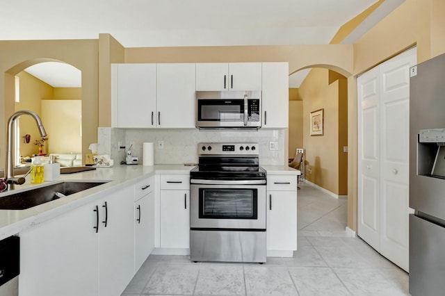kitchen with white cabinets, appliances with stainless steel finishes, and sink