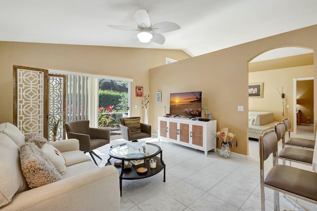 living room with ceiling fan, light tile patterned flooring, and lofted ceiling
