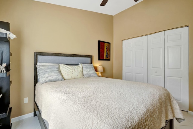bedroom featuring a closet, ceiling fan, and light tile patterned floors