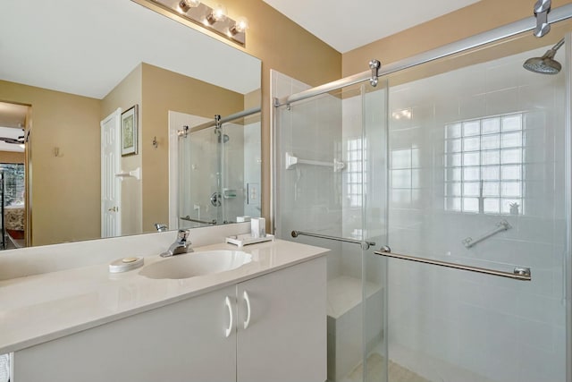bathroom with vanity and a shower with shower door