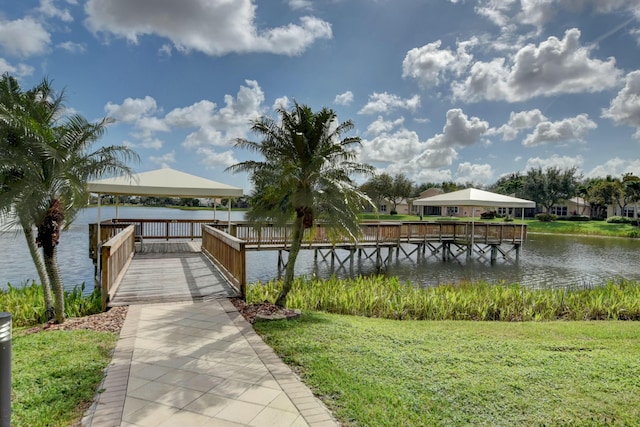 dock area featuring a yard, a water view, and a gazebo