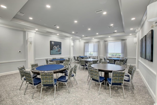dining room with a raised ceiling and crown molding