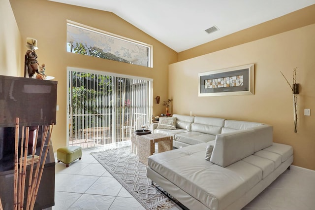 living room with lofted ceiling and light tile patterned floors