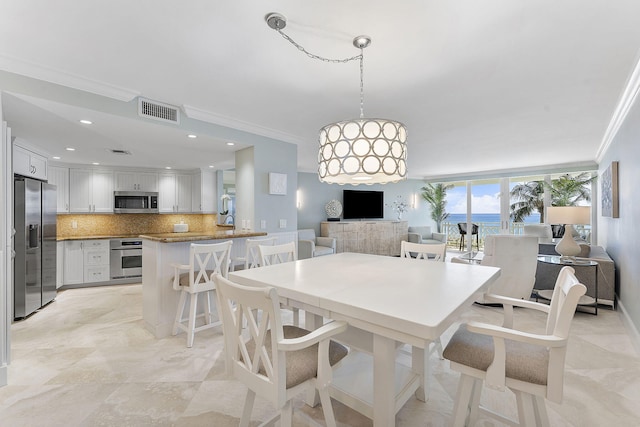 dining room with baseboards, ornamental molding, visible vents, and recessed lighting