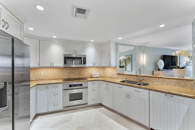 kitchen featuring stainless steel appliances, recessed lighting, tasteful backsplash, visible vents, and a sink