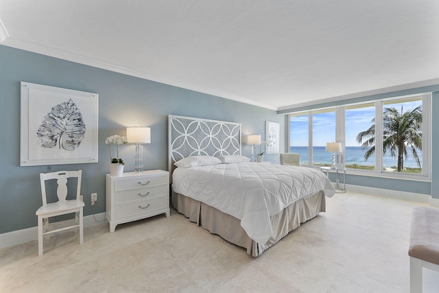 bedroom featuring a water view, baseboards, and crown molding