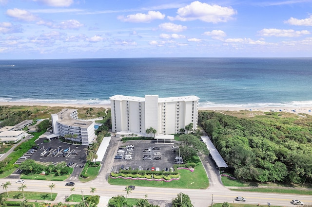 bird's eye view with a water view and a view of the beach