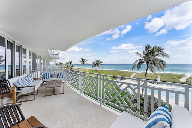 balcony featuring a water view and a view of the beach