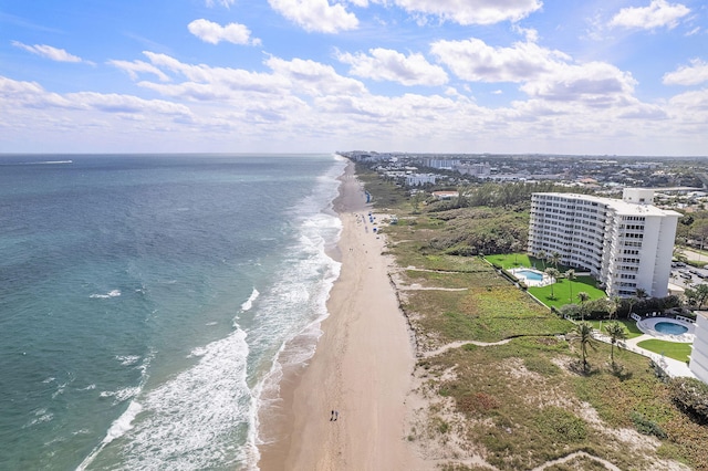 drone / aerial view featuring a water view and a view of the beach