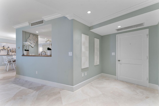 entrance foyer featuring baseboards, visible vents, and ornamental molding