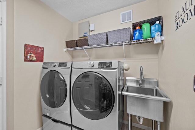 3036 Calle Valencia, West Palm Beach, FL 33409 - laundry room featuring laundry area, visible vents, washer and clothes dryer, and a sink