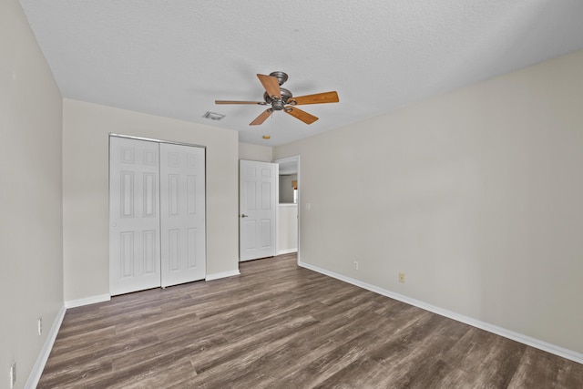 3036 Calle Valencia, West Palm Beach, FL 33409 - unfurnished bedroom featuring visible vents, baseboards, dark wood-style floors, a textured ceiling, and a closet