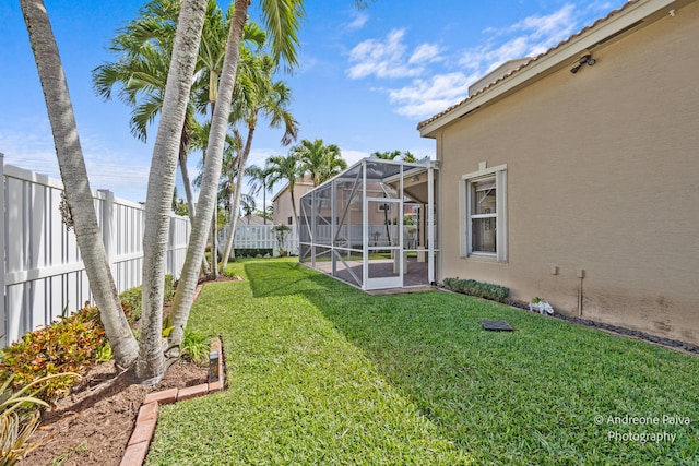 3036 Calle Valencia, West Palm Beach, FL 33409 - view of yard featuring glass enclosure and a fenced backyard