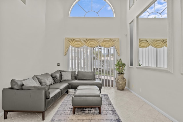 3036 Calle Valencia, West Palm Beach, FL 33409 - living area featuring a towering ceiling, baseboards, and light tile patterned floors