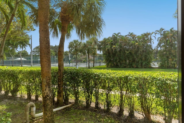 view of home's community featuring fence