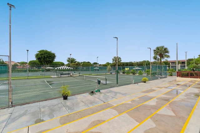 view of tennis court with fence