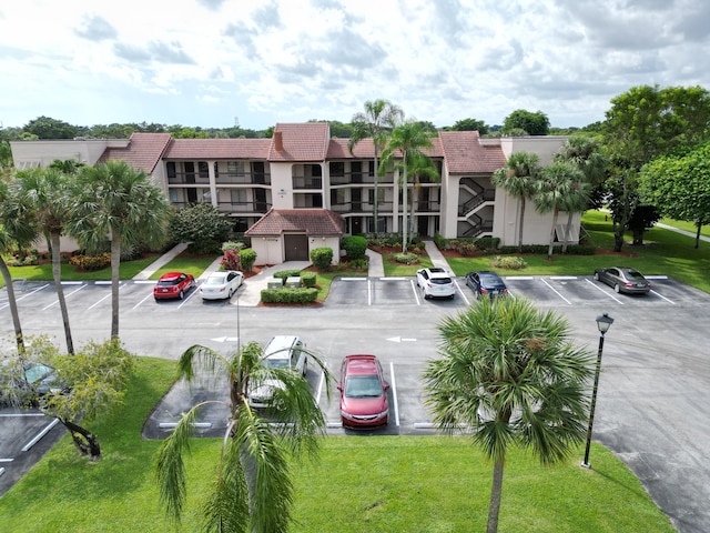 view of property with uncovered parking and a residential view