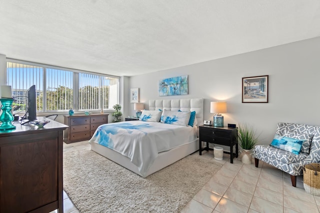 bedroom with a textured ceiling and light tile patterned floors