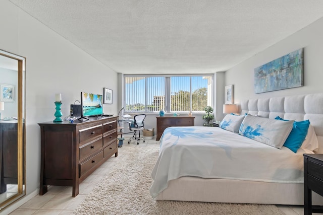 bedroom featuring a textured ceiling and light tile patterned flooring