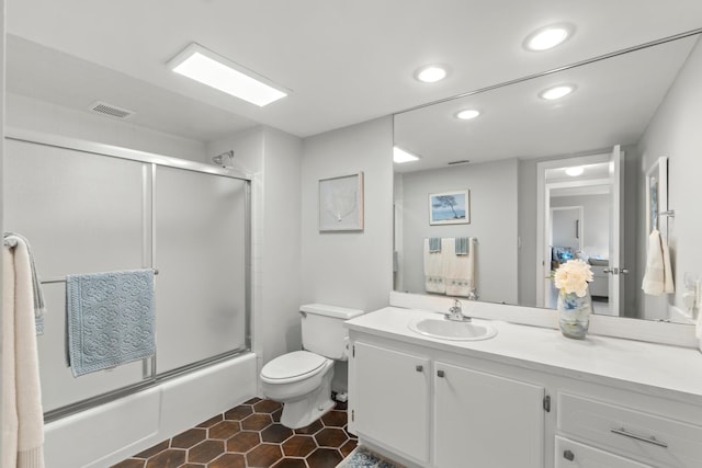 bathroom featuring shower / bath combination with glass door, recessed lighting, toilet, vanity, and tile patterned floors