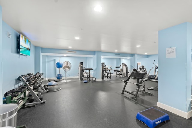 exercise room with recessed lighting and baseboards