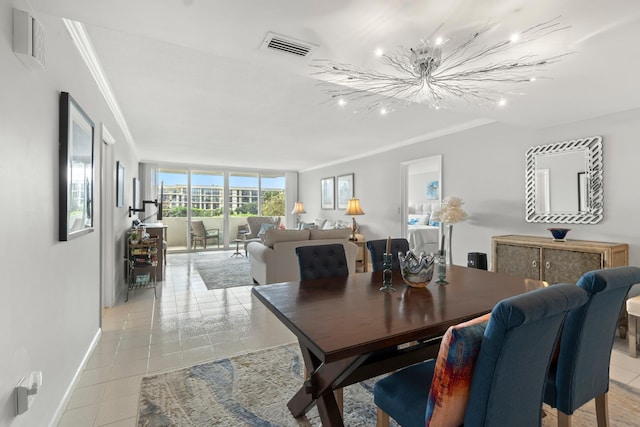 dining room with light tile patterned floors, visible vents, ornamental molding, and baseboards