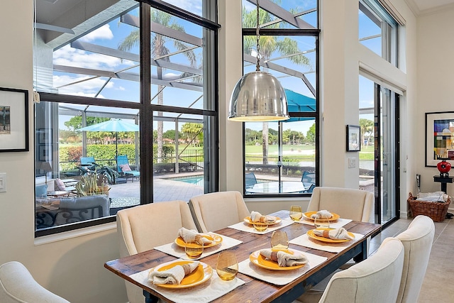 dining area featuring a high ceiling and ornamental molding