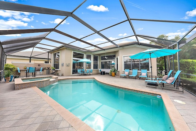 view of swimming pool with a patio area, an in ground hot tub, and a lanai