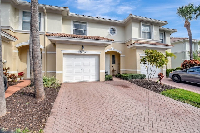 mediterranean / spanish-style home with a garage