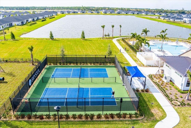 drone / aerial view featuring a water view and a residential view