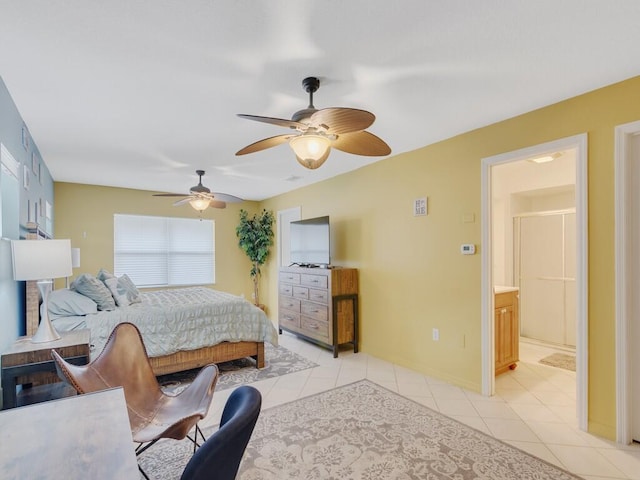 bedroom featuring ensuite bath, light tile patterned floors, and ceiling fan