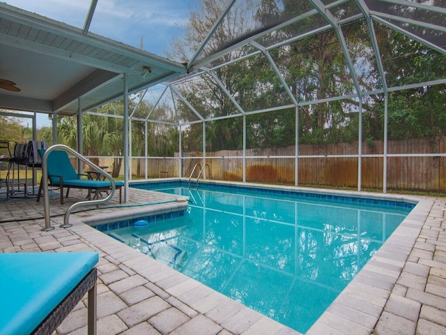 view of swimming pool featuring a patio and a lanai