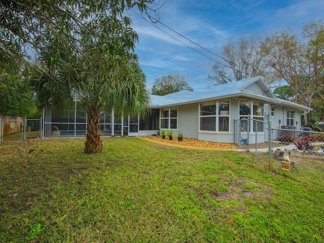 back of house with a lawn