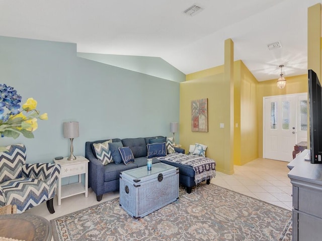 living room featuring lofted ceiling and light tile patterned floors