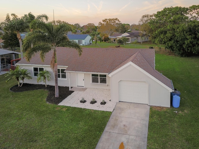 single story home with a yard and a garage