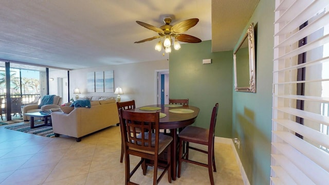 2400 S Ocean Dr Unit 2328, Fort Pierce, FL 34949 - dining area featuring expansive windows, a ceiling fan, and light tile patterned floors