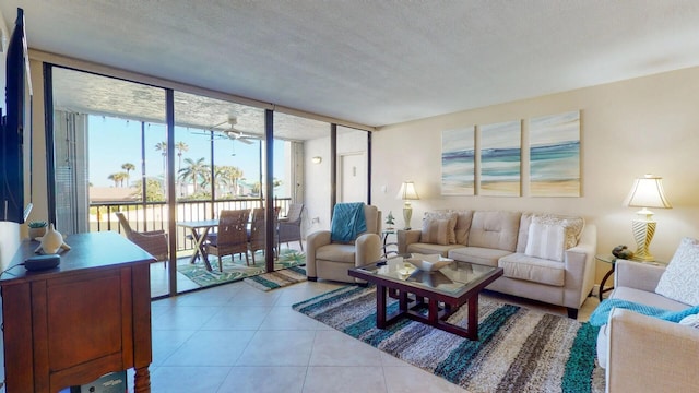 tiled living room featuring a textured ceiling and expansive windows