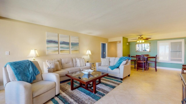 tiled living room featuring ceiling fan and a textured ceiling